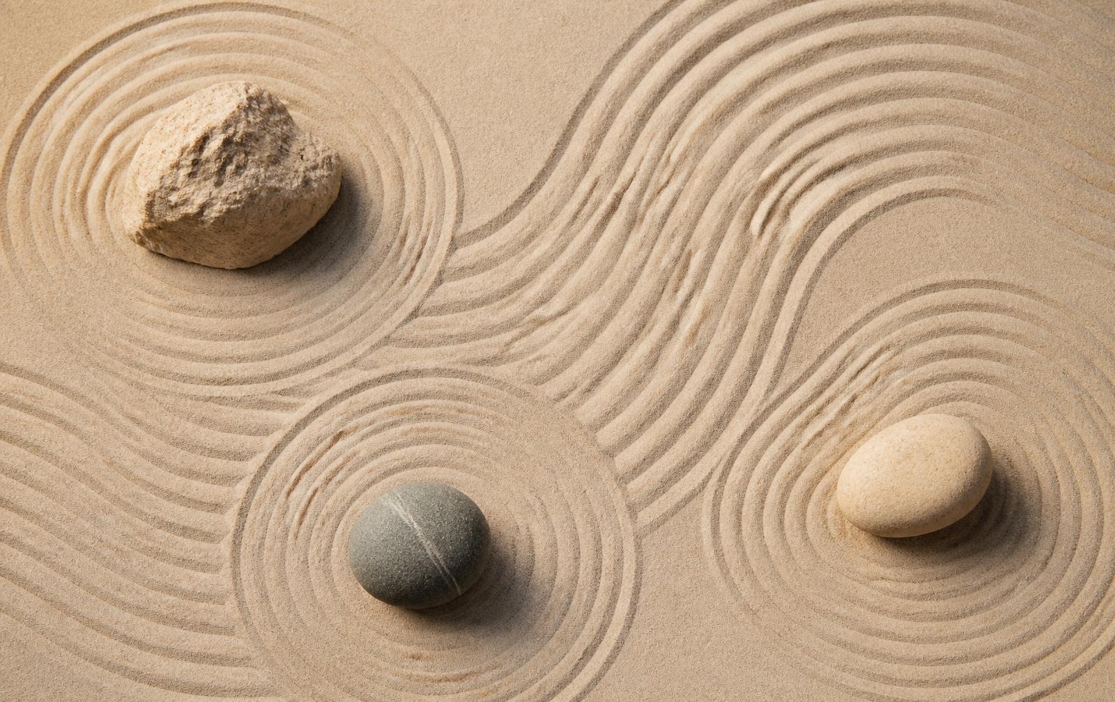 Raked sand zen garden with stones